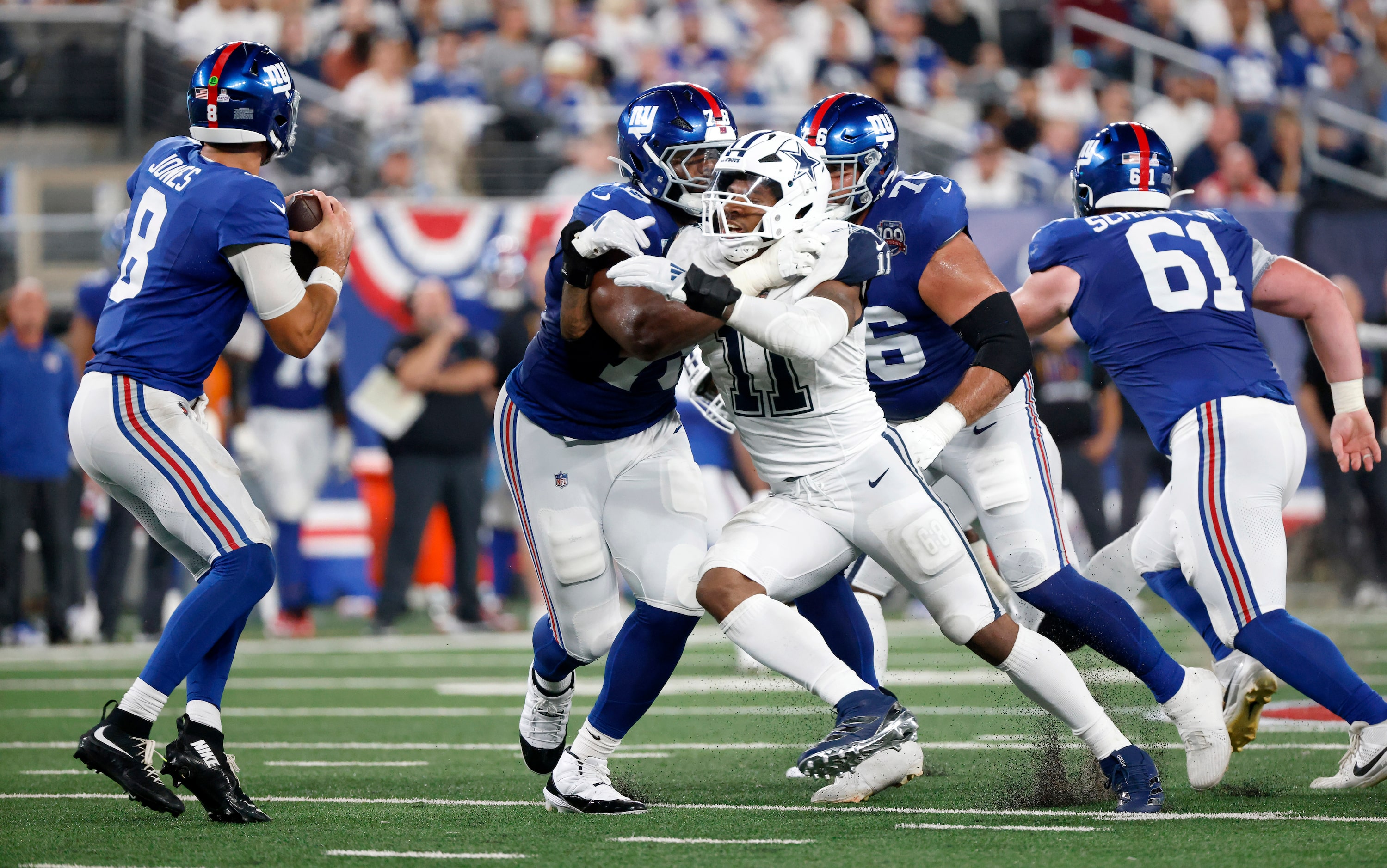 Dallas Cowboys linebacker Micah Parsons (11) pass rushes New York Giants quarterback Daniel...