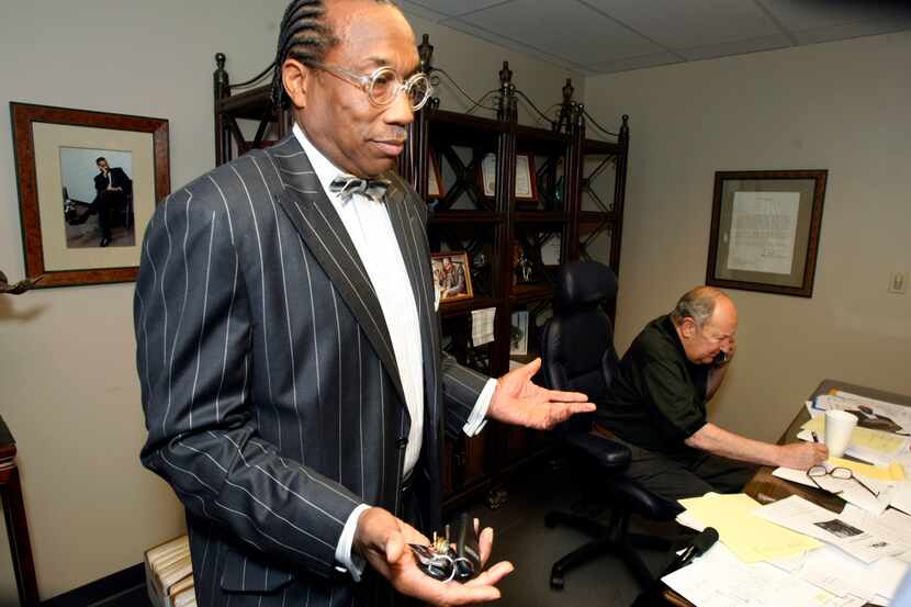 Dallas County Commission John Wiley Price, left, talks to the news media in the law offices...