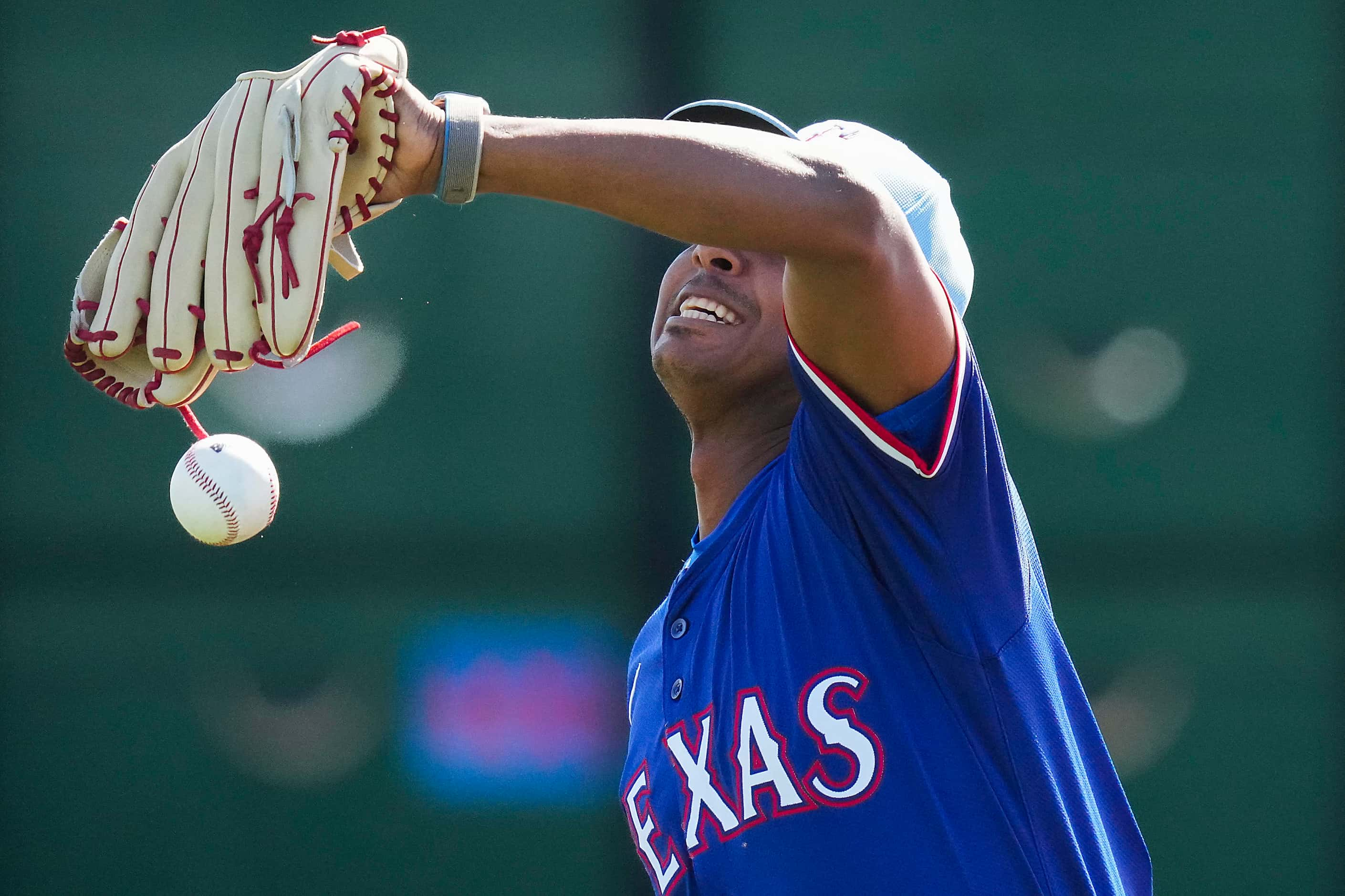 Texas Rangers pitcher José Leclerc can’t make a catch in a fielding drill during a spring...