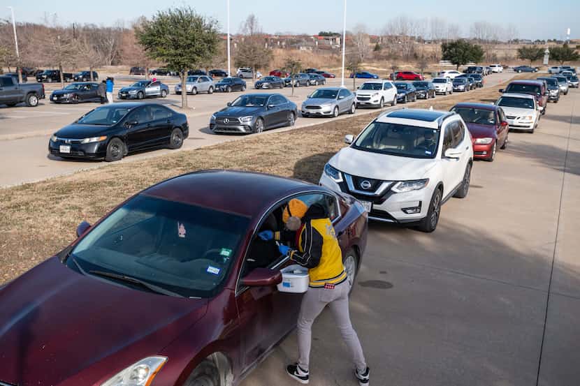 Healthcare worker Tonya Gallow administers a COVID-19 test in the parking lot of ...