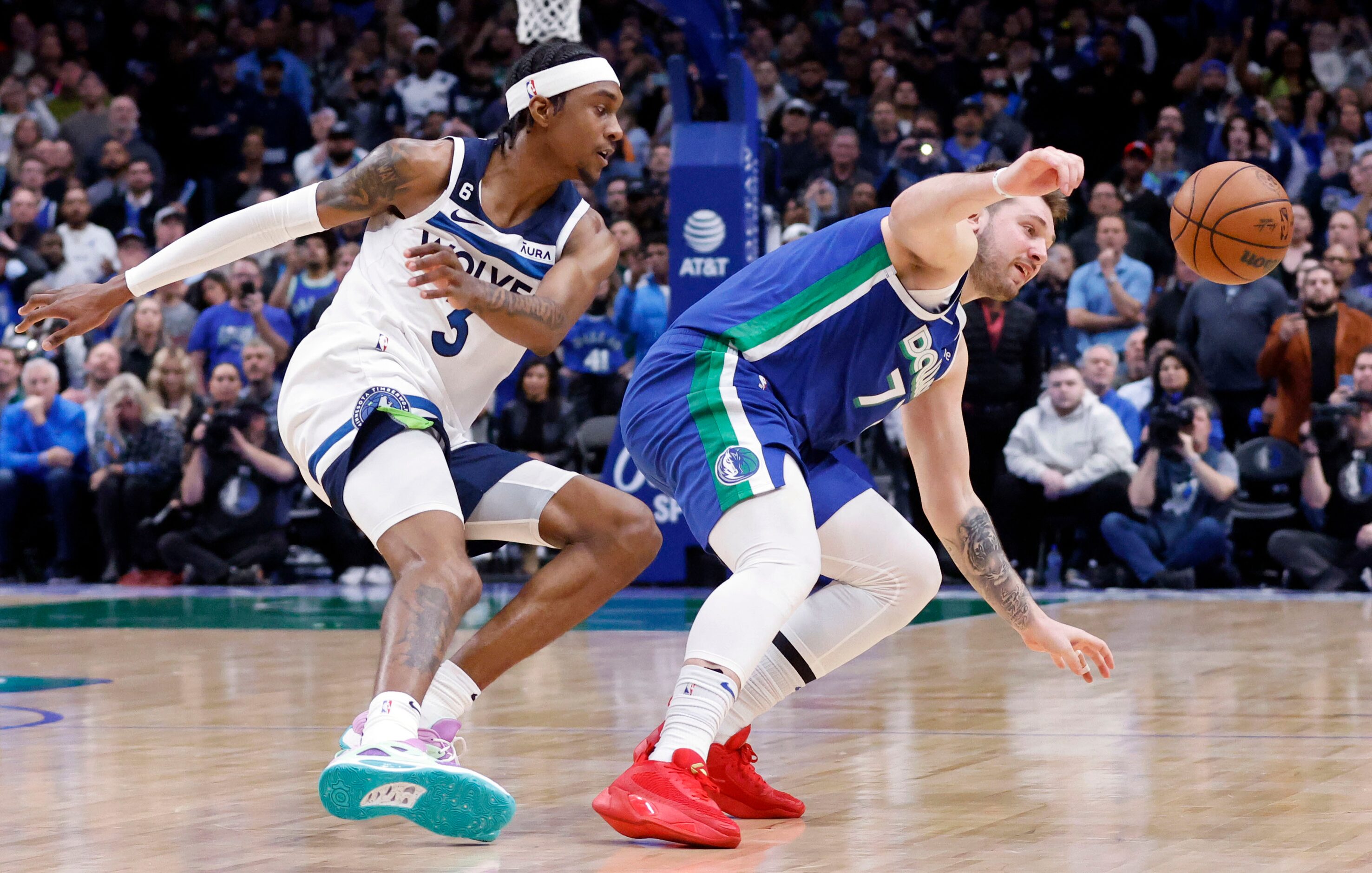 Dallas Mavericks guard Luka Doncic (77) chases down the ball after having it  knocked away...