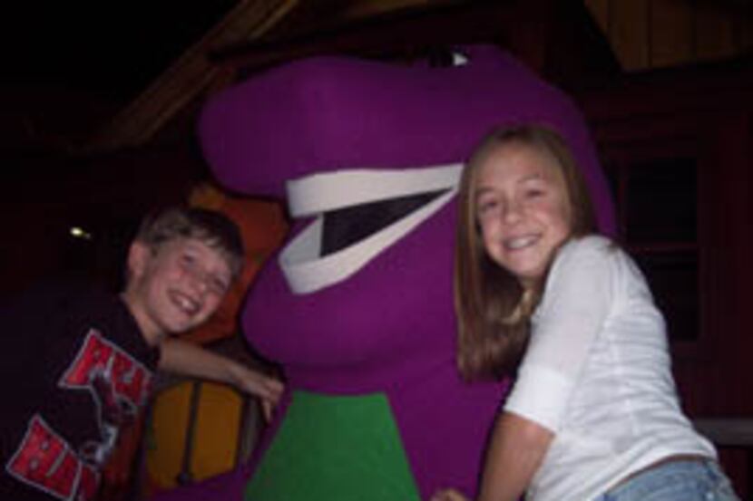 Reese Wilson and his older sister Molly Wilson join Barney the purple dinosaur while on set...
