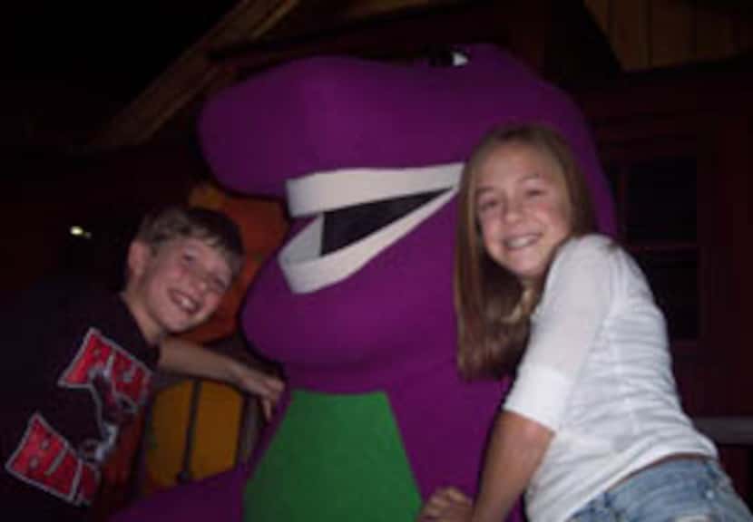Reese Wilson and his older sister Molly Wilson join Barney the purple dinosaur while on set...