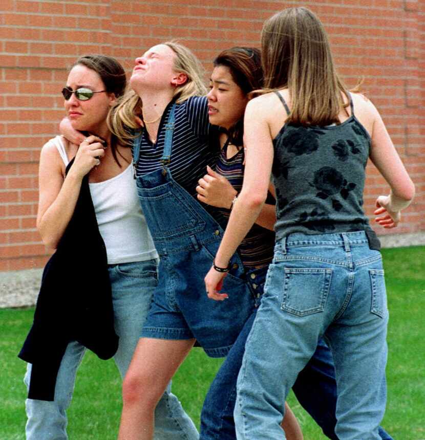 In this April 20, 1999 file photo, unidentified young women head to a library near Columbine...