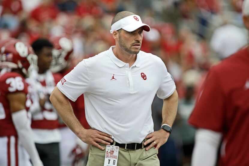Defensive coordinator Alex Grinch observers warm ups before the game against the Texas Tech...
