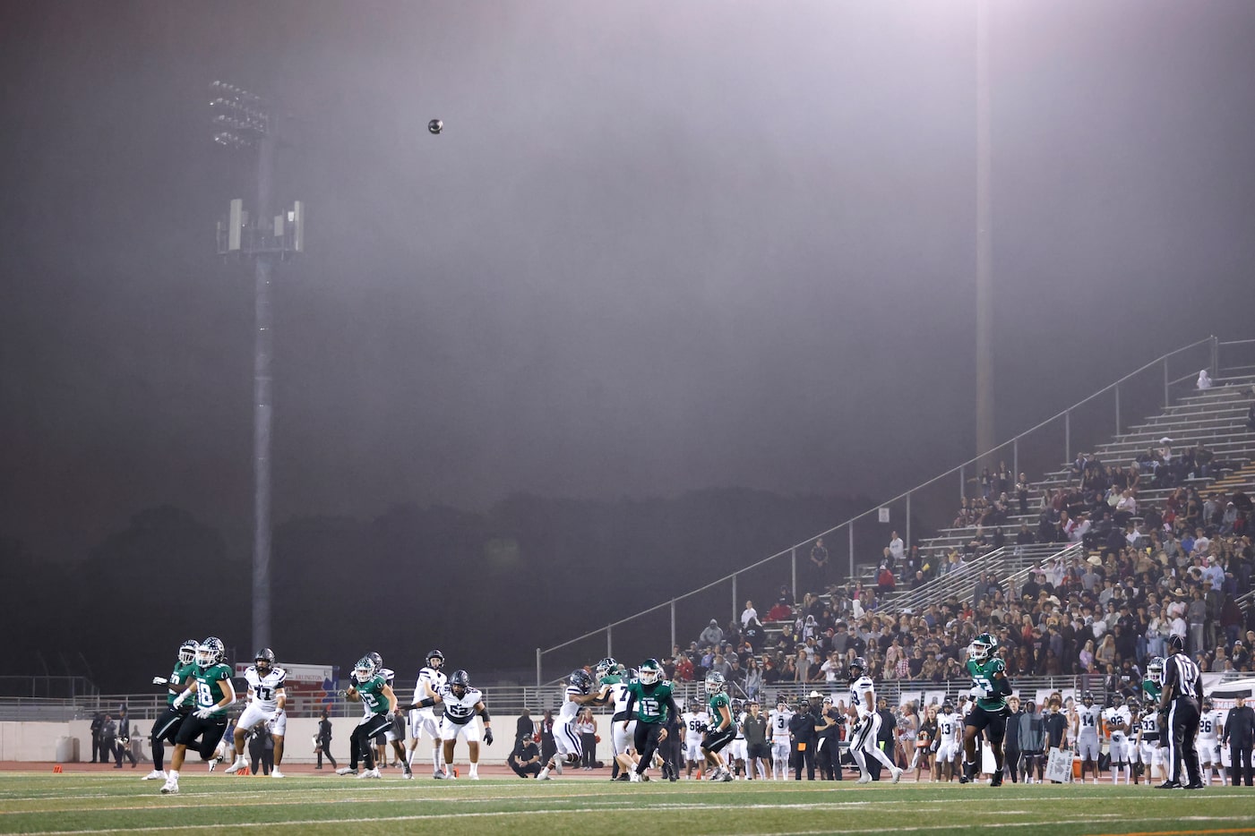 In a heavy mist, Arlington Martin quarterback Hunter Squires heaves a long, second quarter...