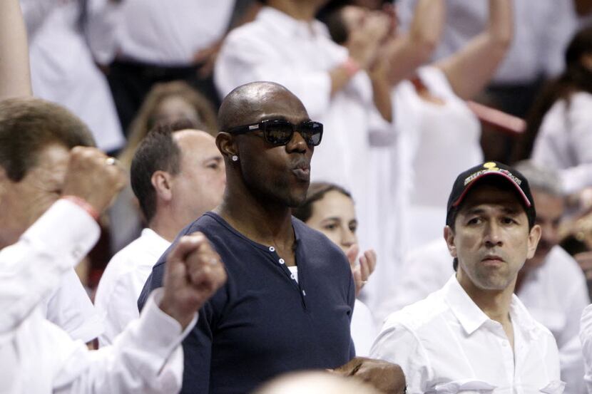 FILE - Former Dallas Cowboys receiver Terrell Owens in the stands watching a game between...