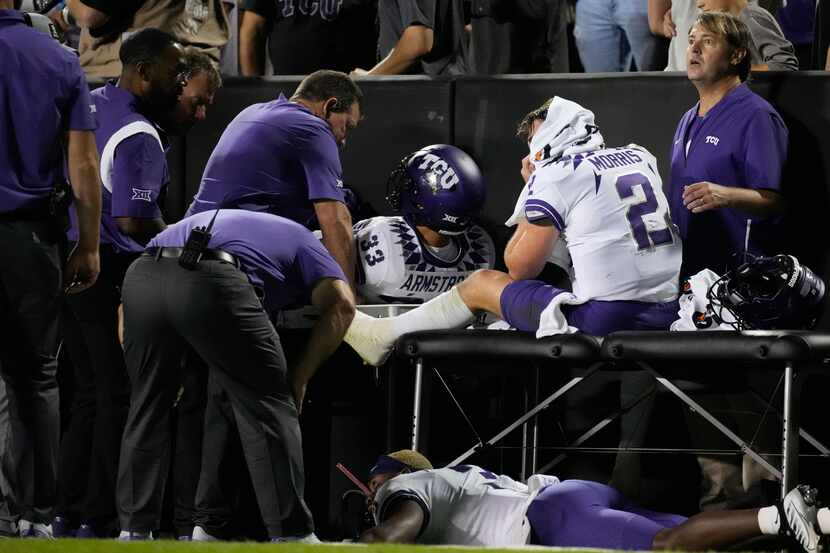 TCU quarterback Chandler Morris, right, is attended to by trainers after being injured while...