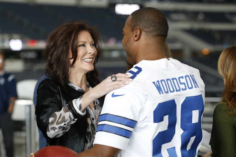 Charlotte Jones Anderson, executive vice president of the Dallas Cowboys gives a hug to...
