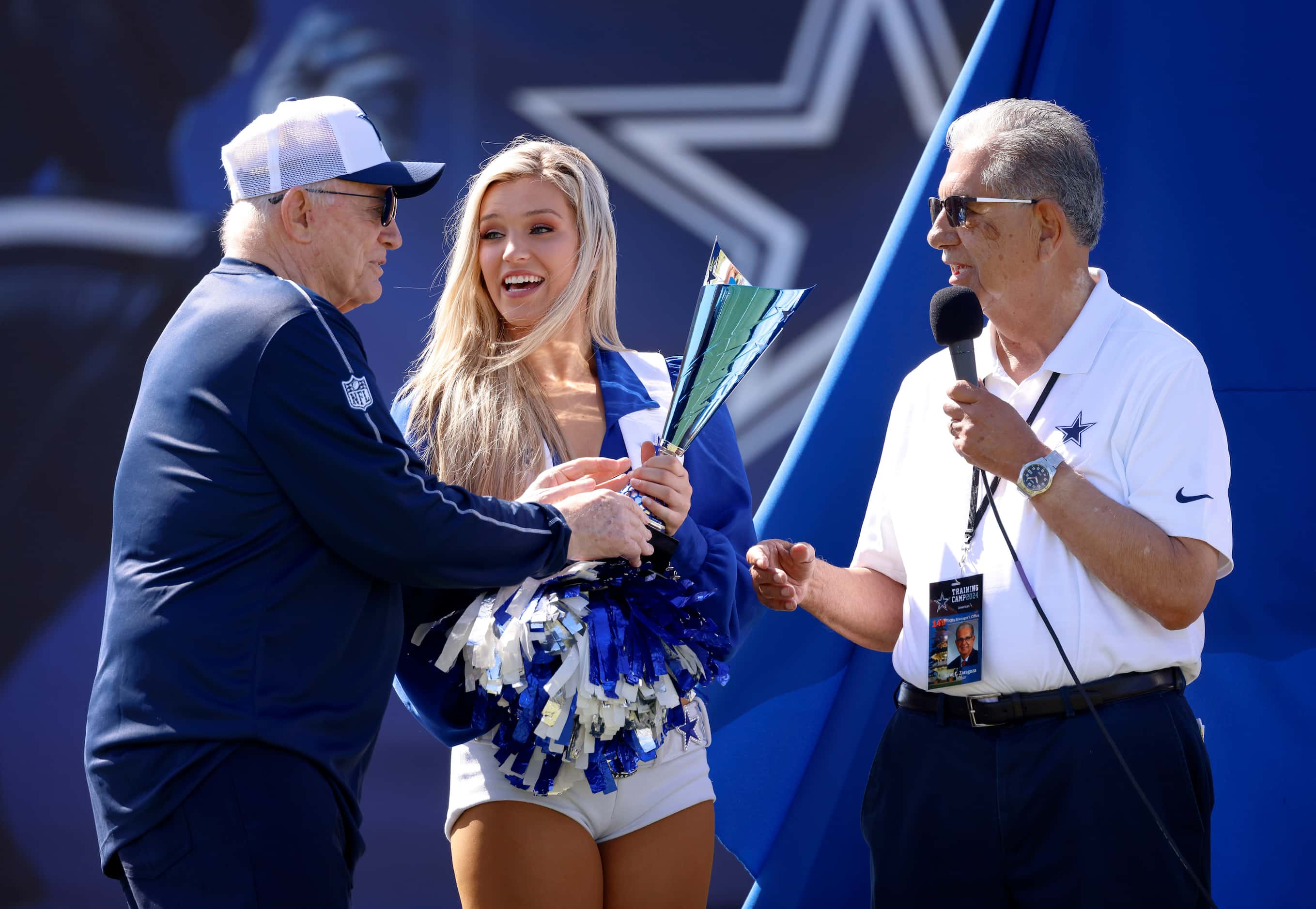 Dallas Cowboys owner Jerry Jones (left) hands a trophy gifted him by Oxnard Mayor John C....