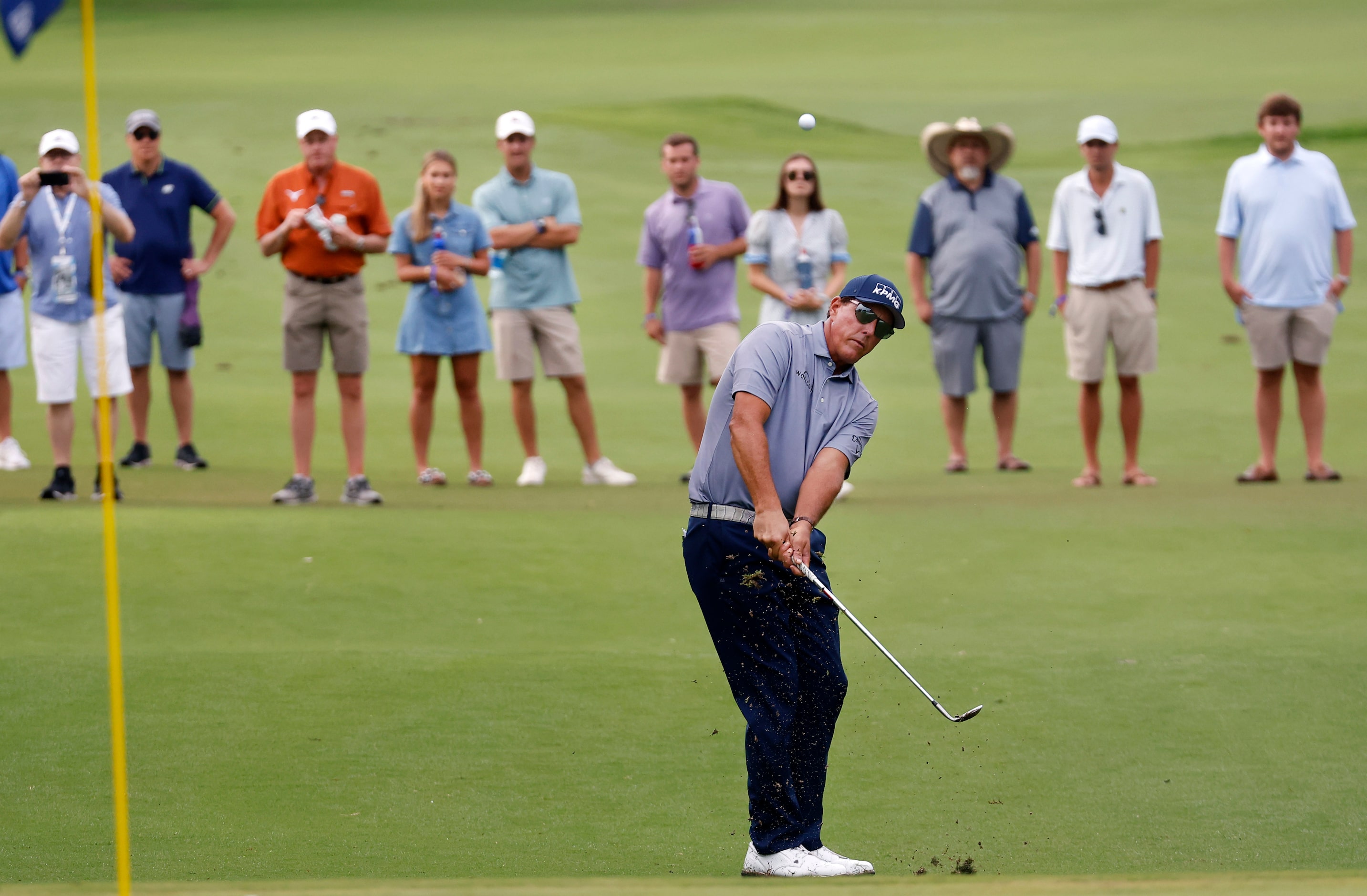 Professional golfer Phil Mickelson chips onto the No. 14 green during round two of the...