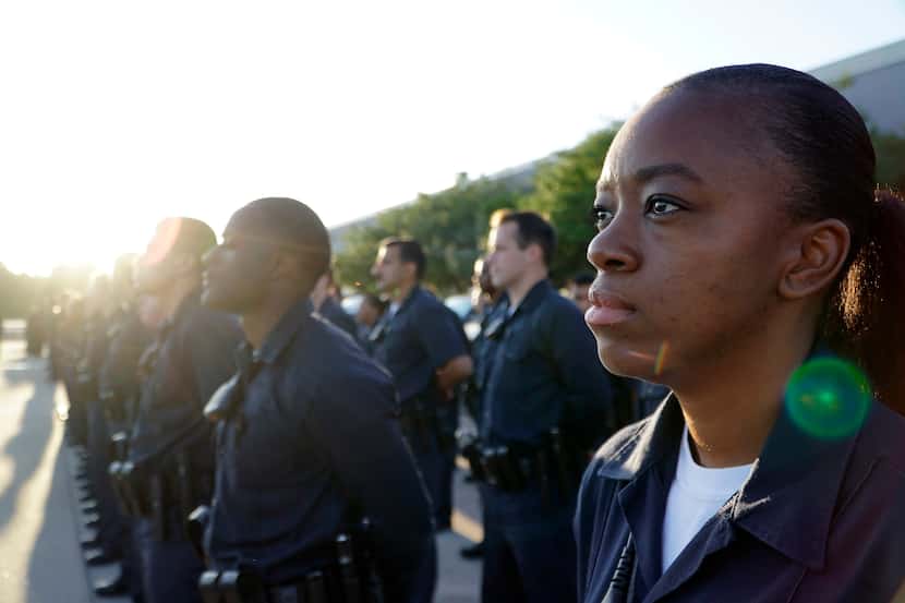 Dallas police recruit Cherika Smith stands in formation with her classmates during morning...