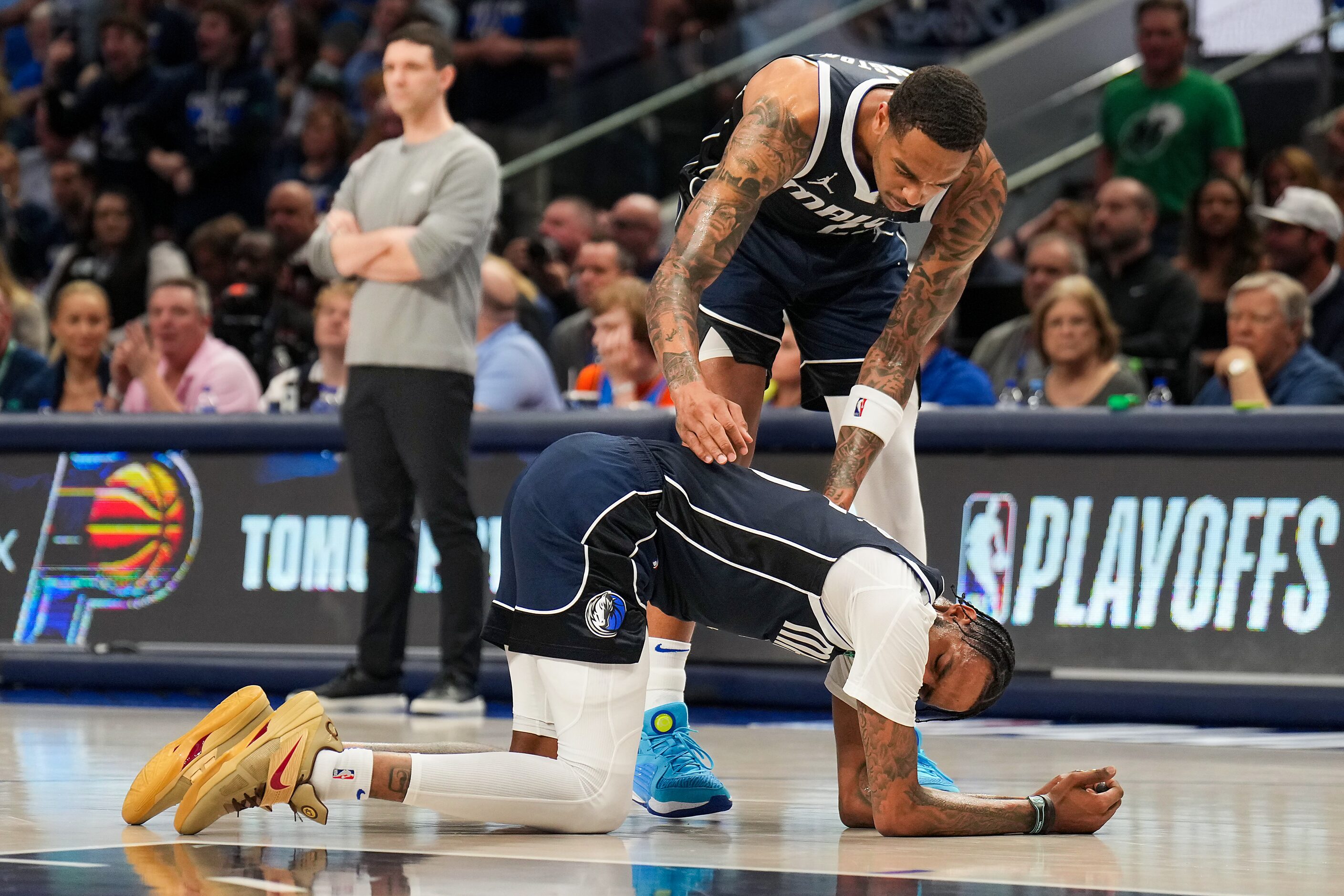 Dallas Mavericks forward P.J. Washington (25) checks on  forward Derrick Jones Jr. (55)...