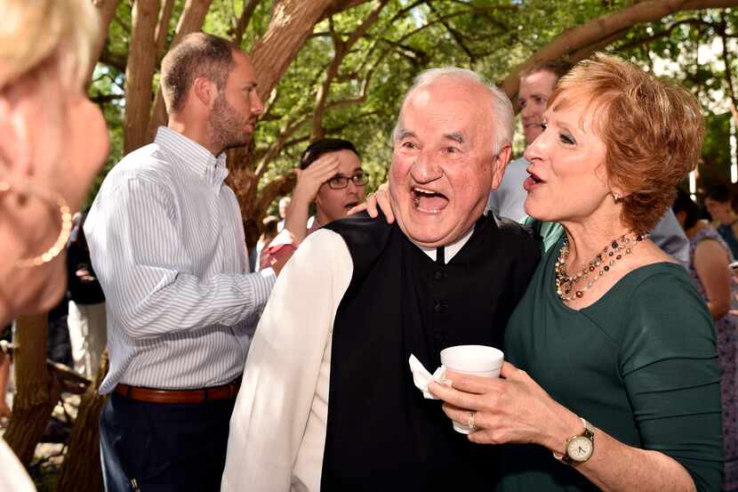 The Rev. Bernard Marton is congratulated by Cistercian Preparatory nurse Kathy Nevitt,...