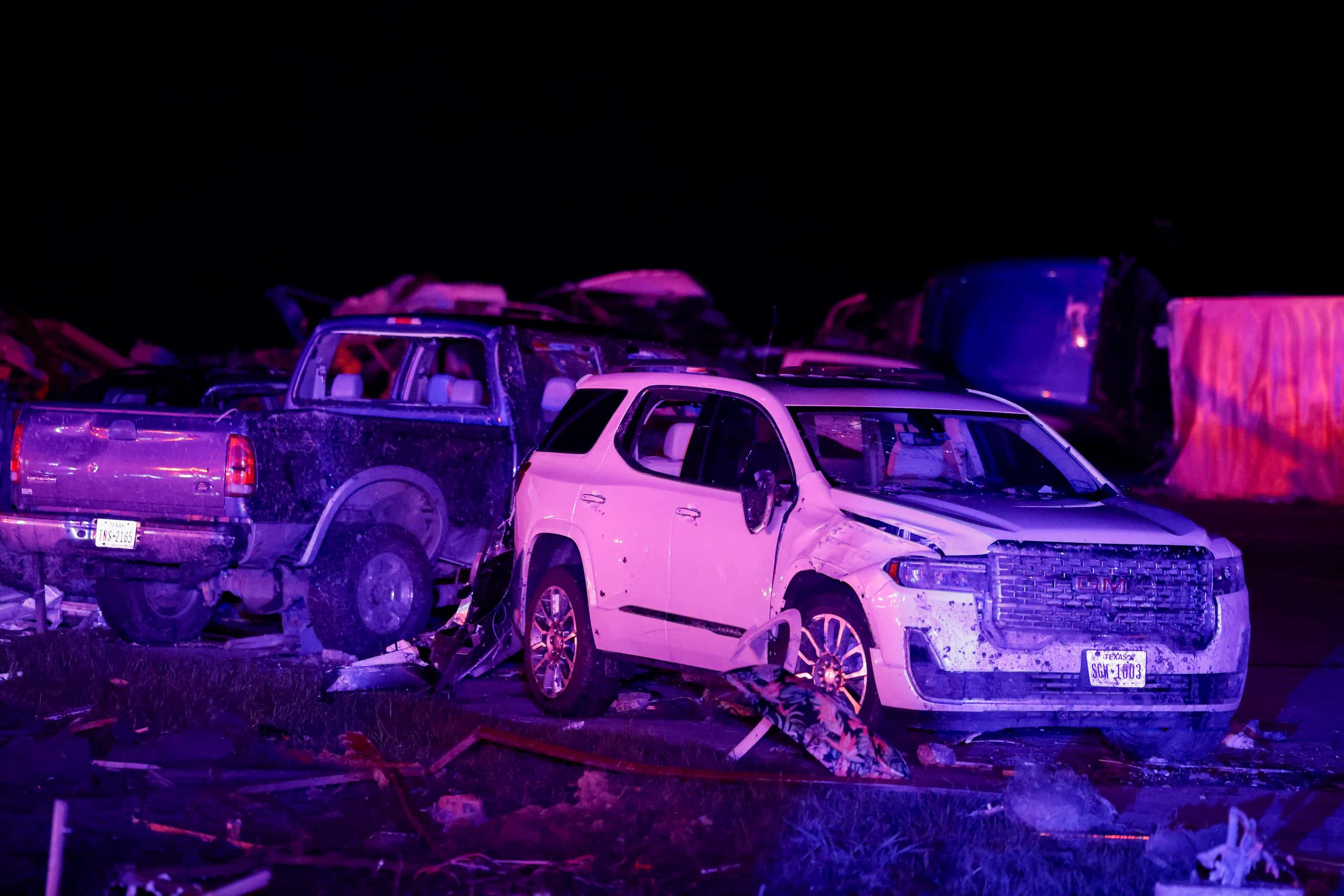 Several heavily damaged vehicles are seen near a Shell gas station after a suspected tornado...