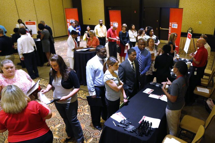 
Job hunters talked to State Farm Insurance representatives during a career fair in...