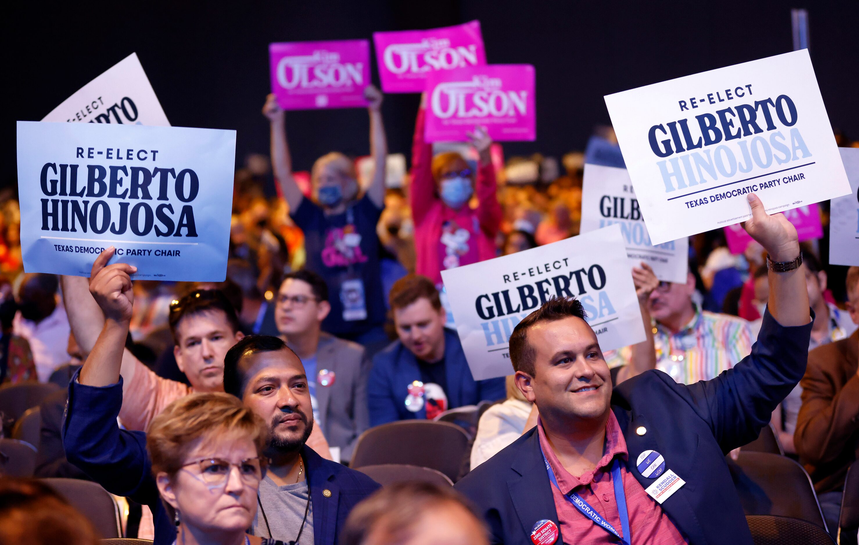 Supporters of incumbent Gilberto Hinojosa and challenger Kim Olson cheer their support...