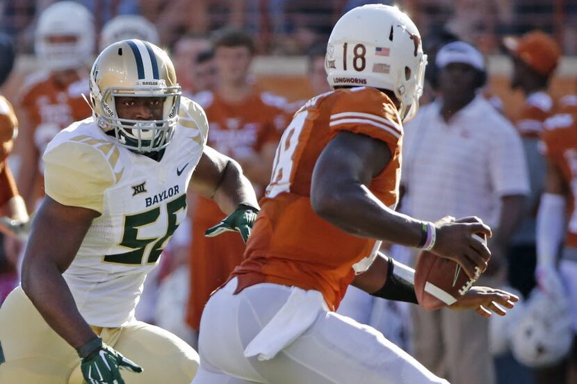 Baylor defensive end KJ Smith (56) rushes Texas quarterback Tyrone Swoopes (18) during the...