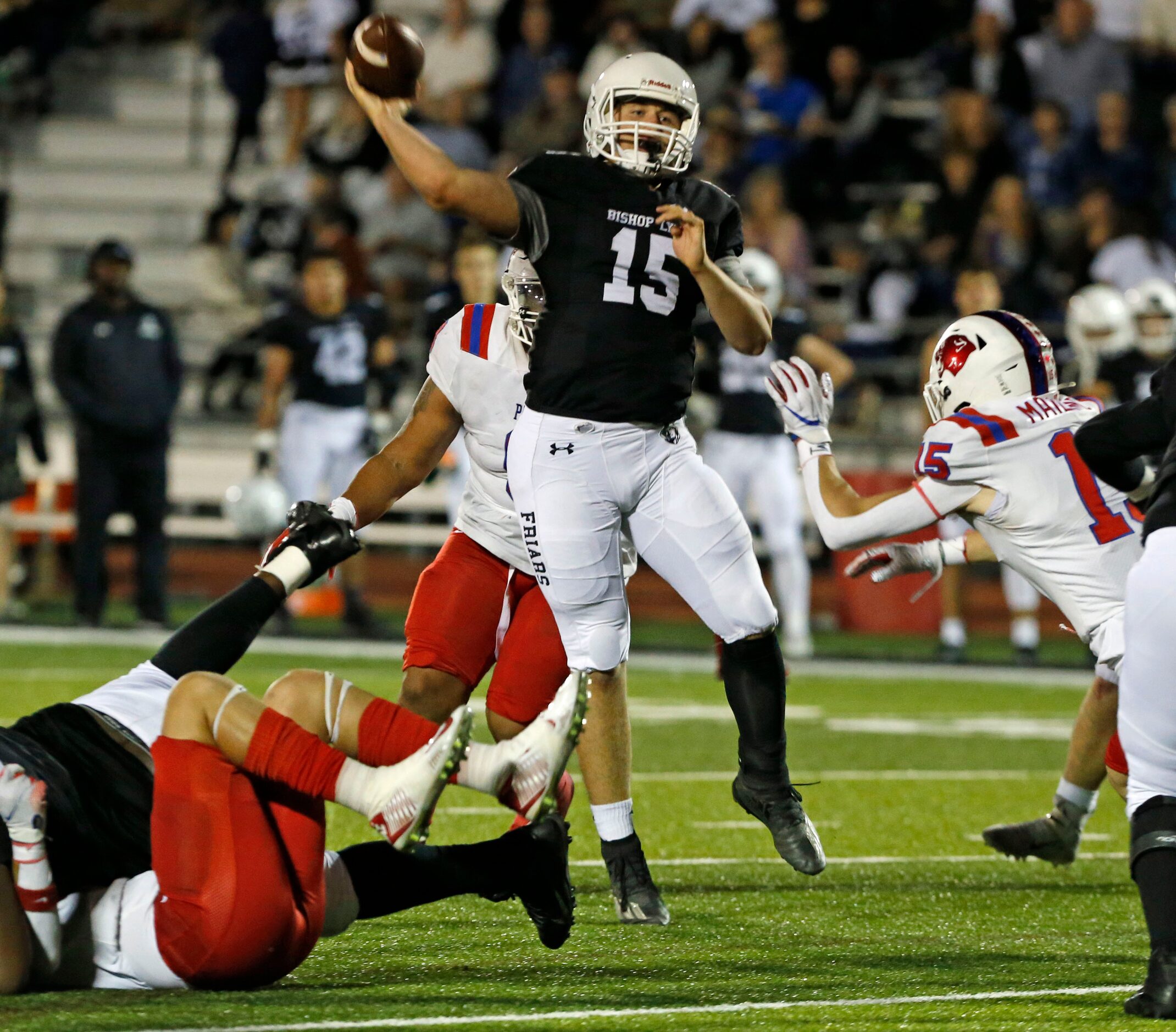 Bishop Lynch QB Cooper Alford (15) throws under pressure during the first half of a high...