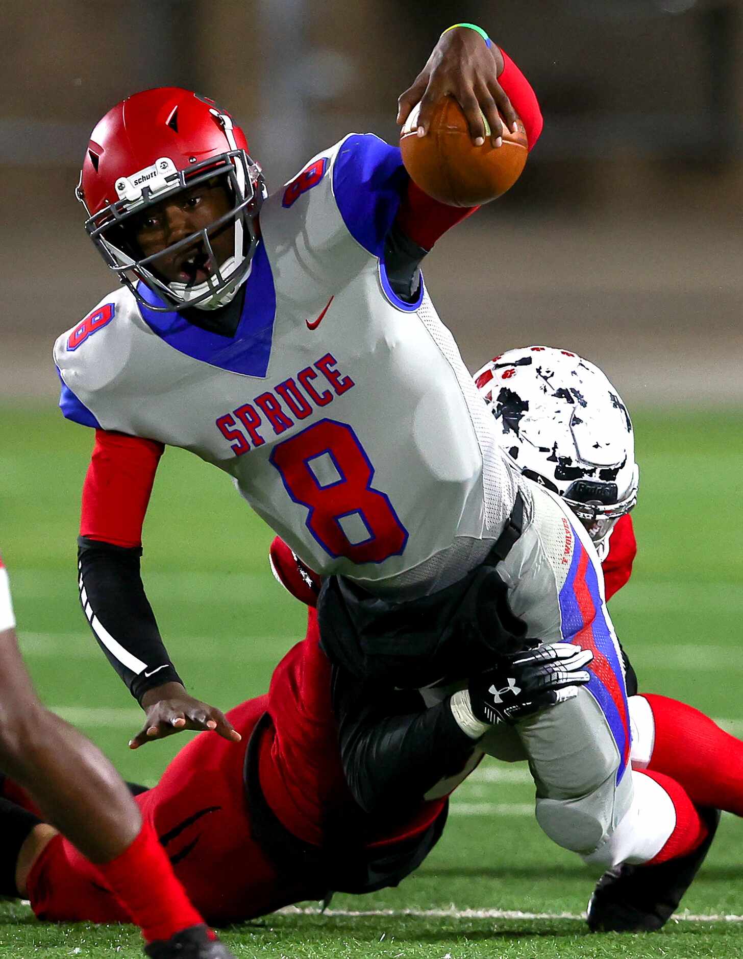 Spruce quarterback Kelvin Jones (8) stretches out for a first down against Hillcrest...