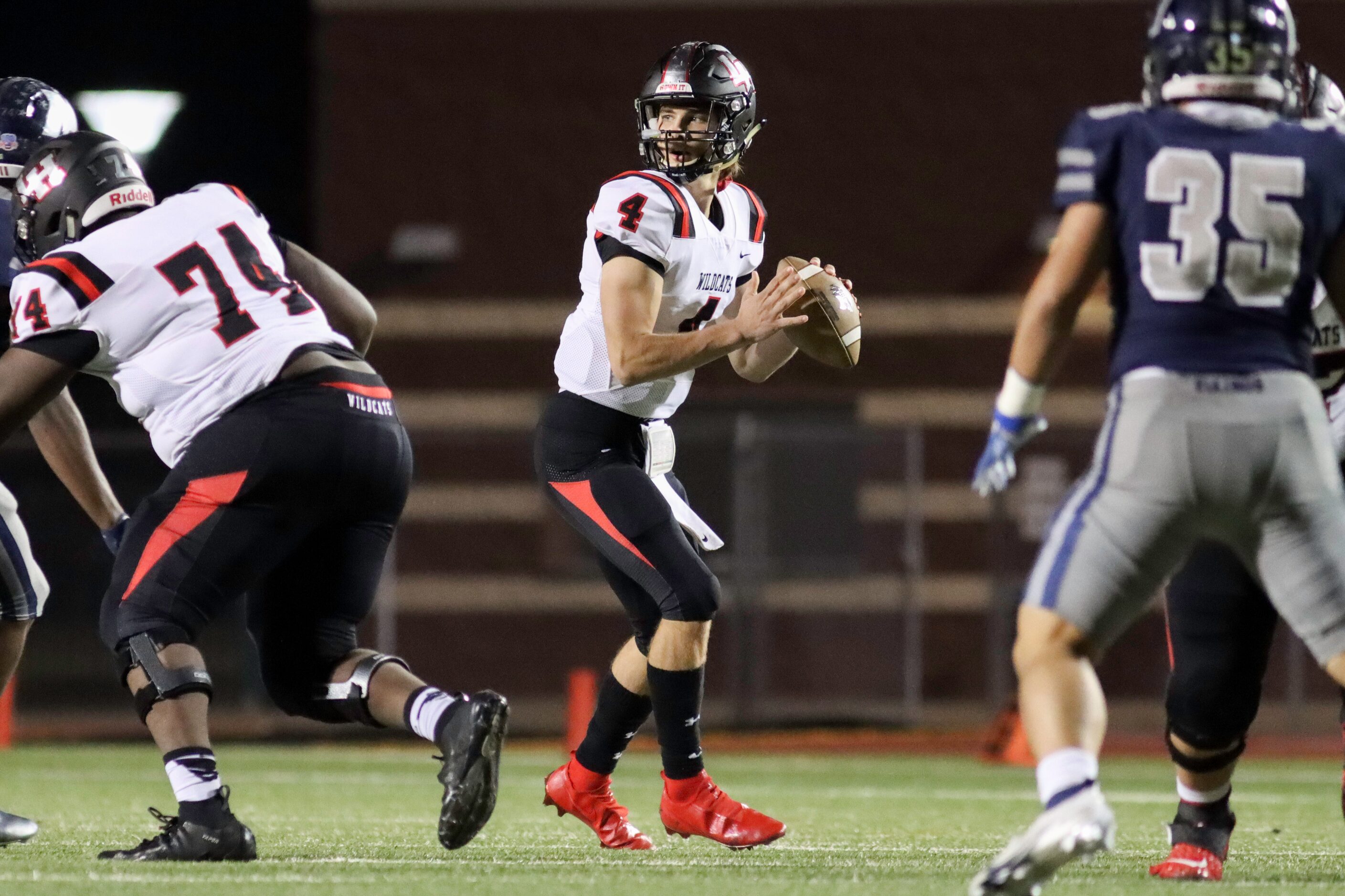 Lake Highlands offensive lineman Samuel Odelami (74) blocks for quarterback Caden Dotson (4)...