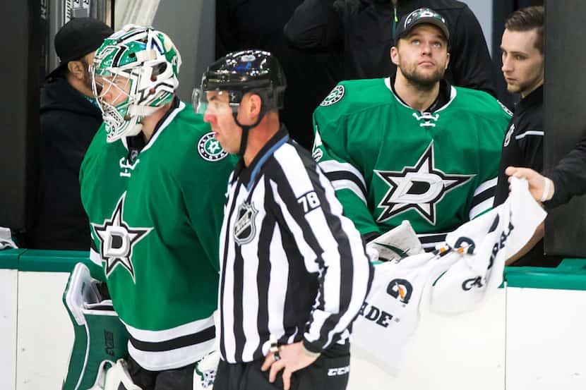 Dallas Stars goalie Antti Niemi (right) watches from the bench as fellow goalie Kari...