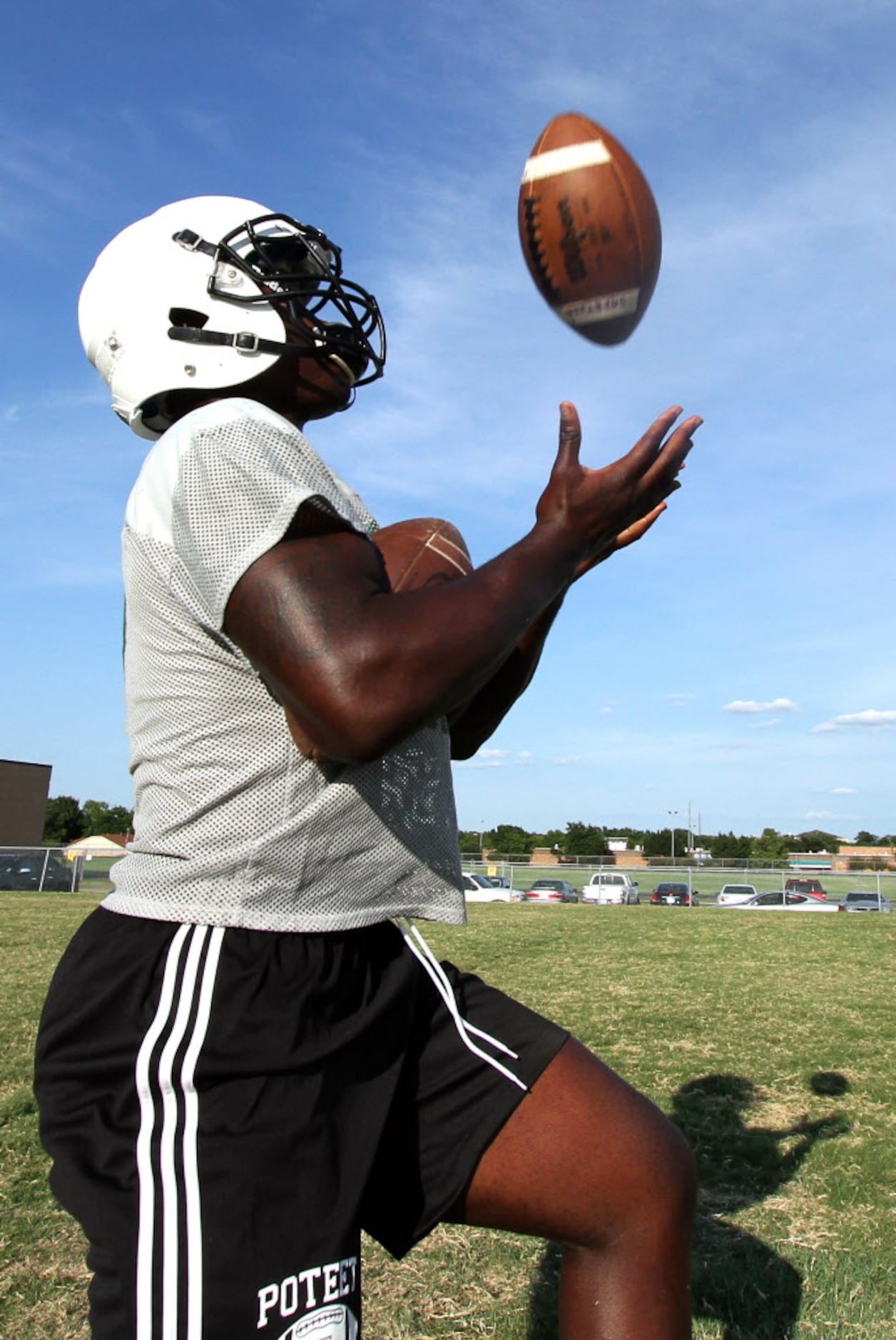 Mesquite Poteet defensive back Deandre McNeal pulls in a high pass while holding a football...