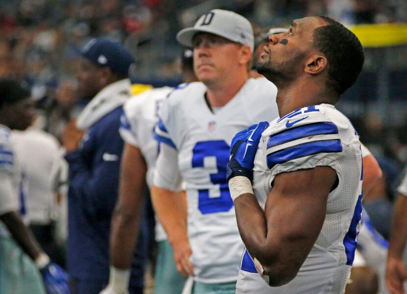 Dallas Cowboys running back Joseph Randle (21), right, and quarterback Brandon Weeden (3)...