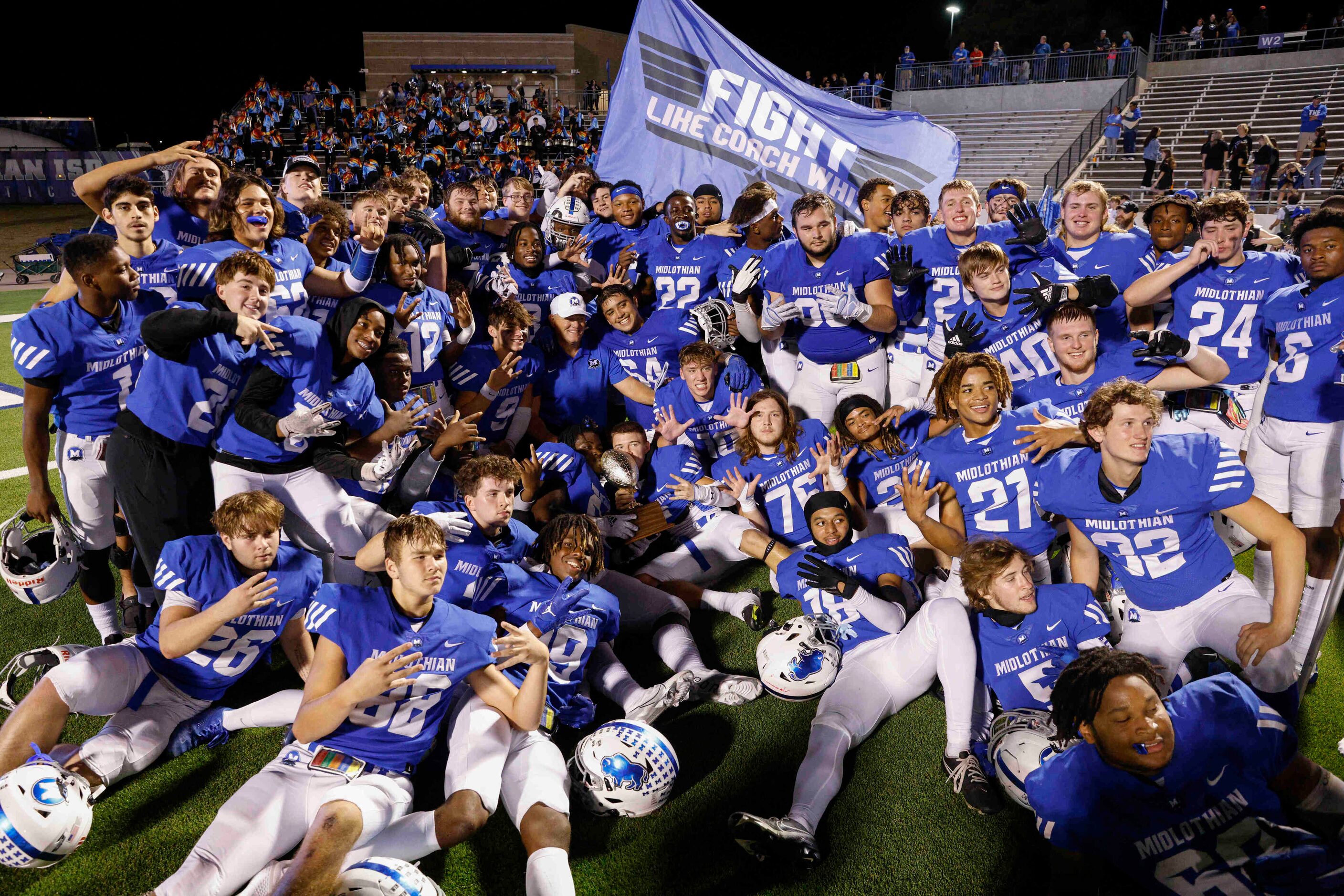 Midlothian players pose for photos after winning District 4-5A Division I at Midlothian ISD...