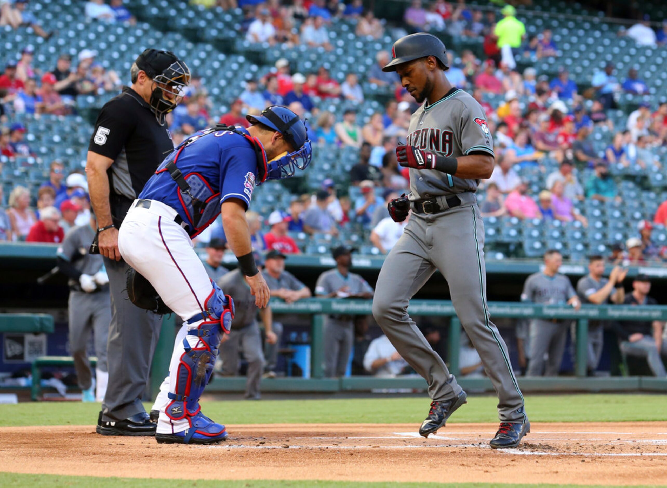 Arizona Diamondbacks Jarrod Dyson (1) scores in the first inning of a baseball game against...