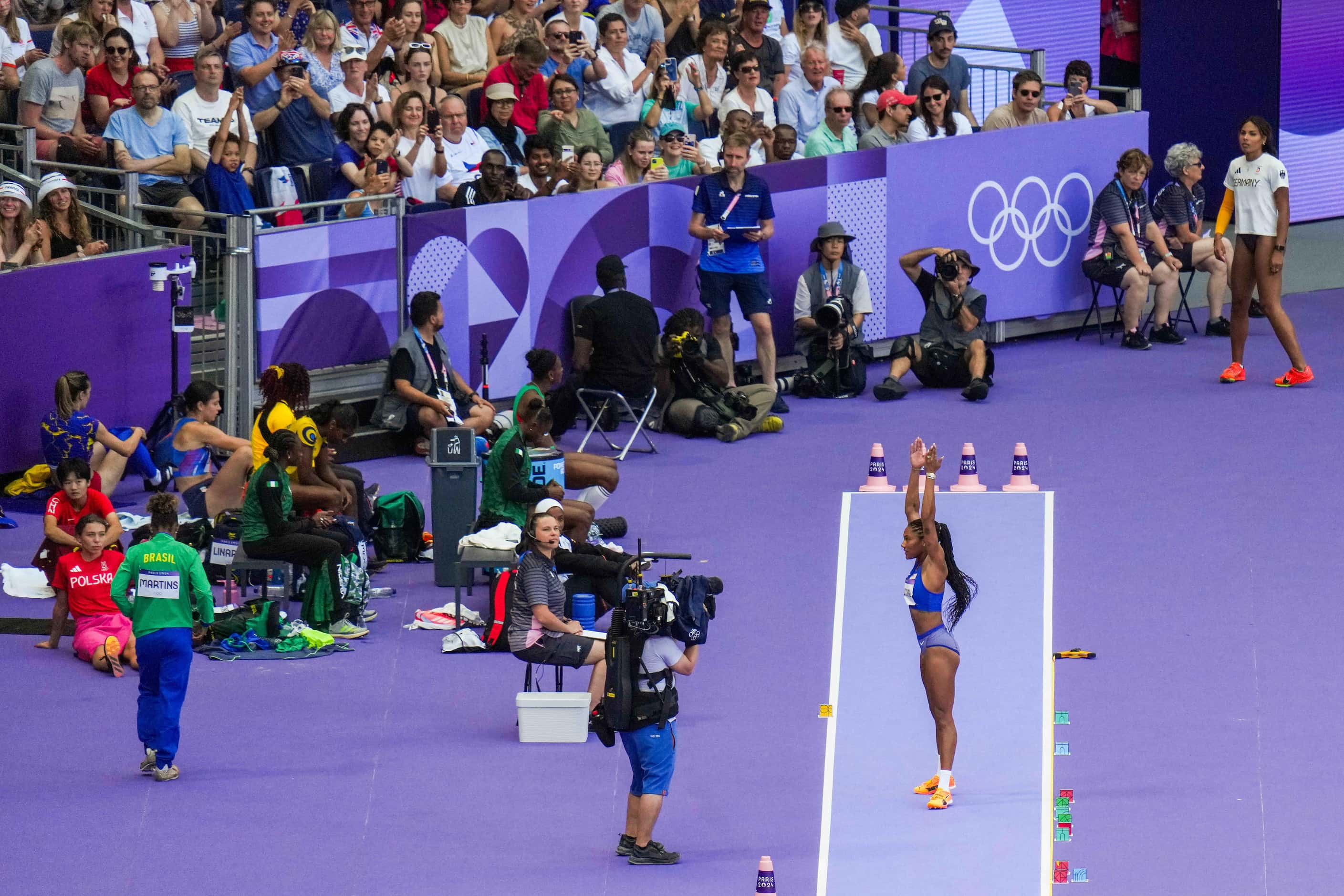 Tara Davis-Woodhall of the United States encourages the crowd to clap as she prepares to...