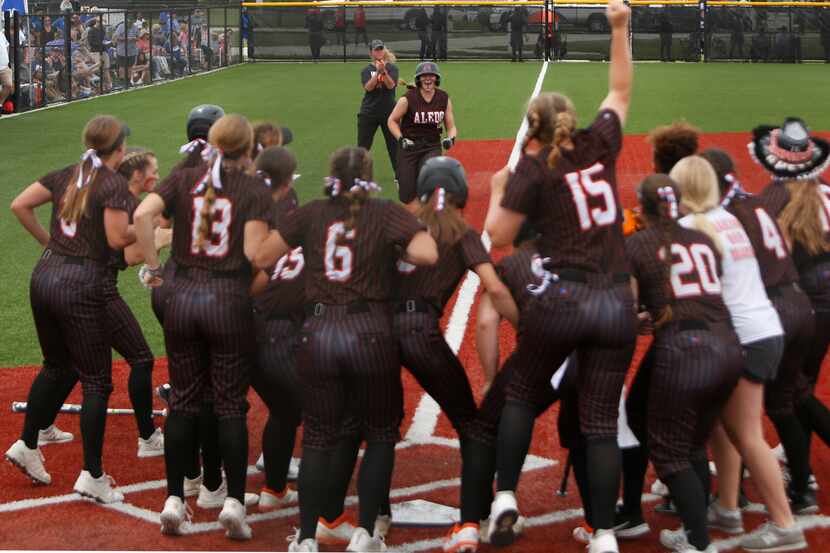 Aledo outfielder Marissa Powell (11) received quite the reception at home plate after...