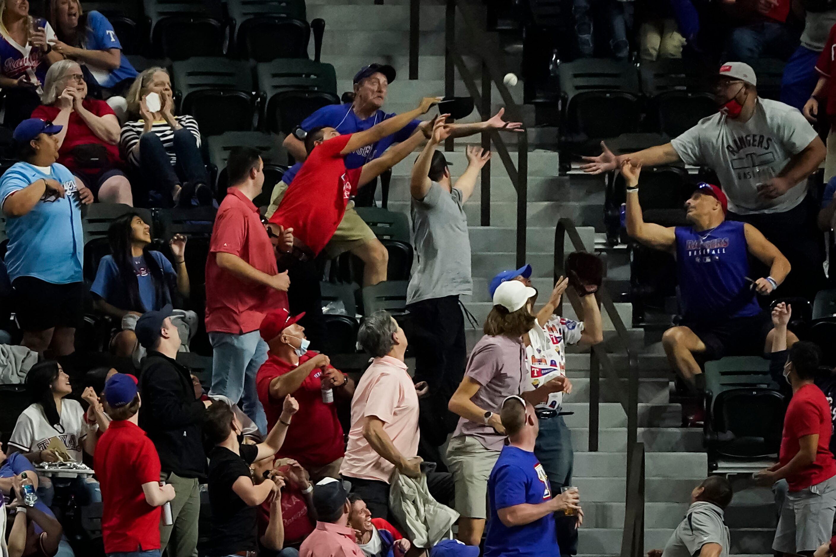 Fans reach for the ball on a 2-run home run by San Diego Padres center fielder Trent Grisham...