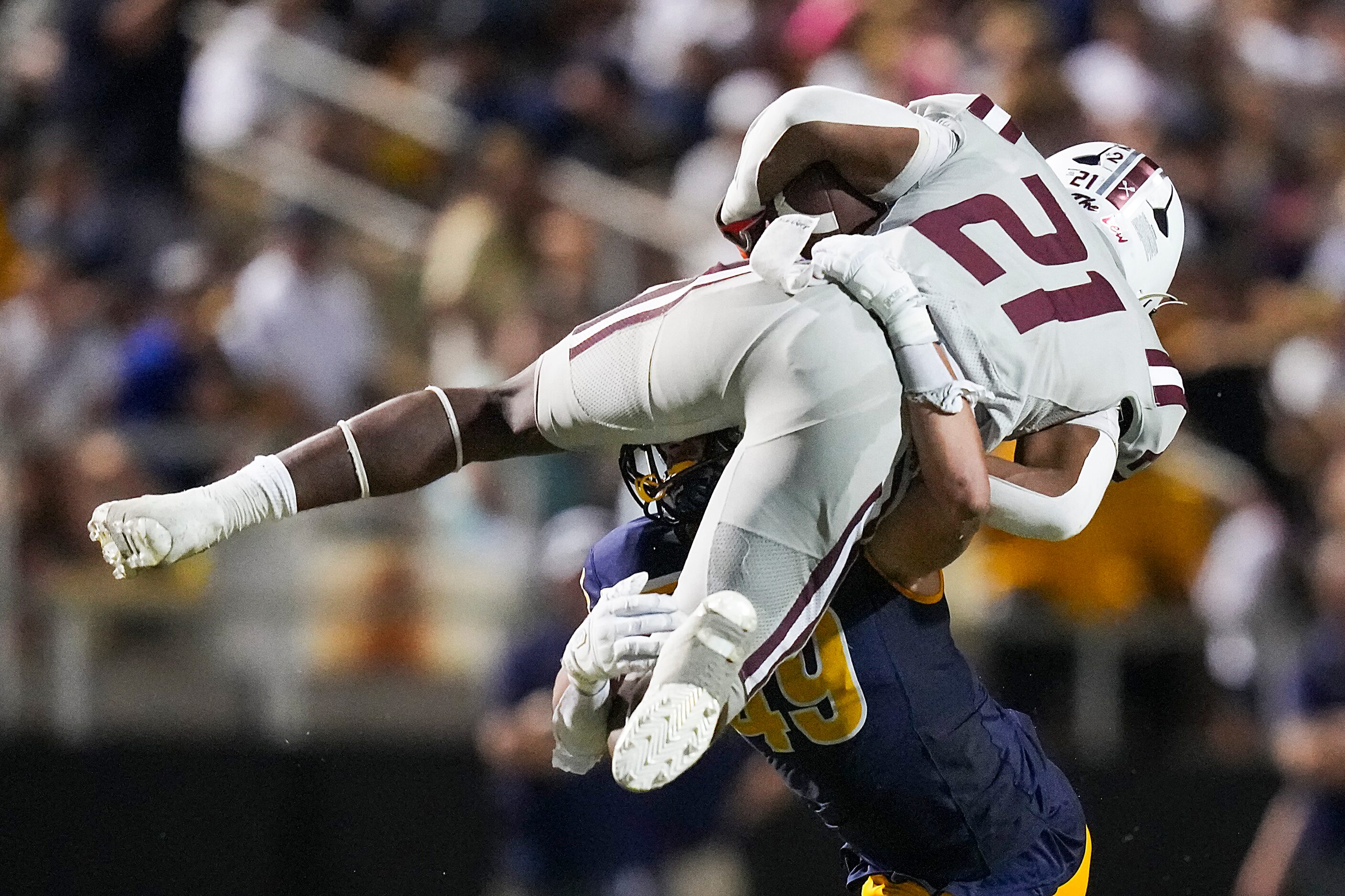 Lewisville running back Viron Ellison (21) is stopped as he tries to leap Highland Park...