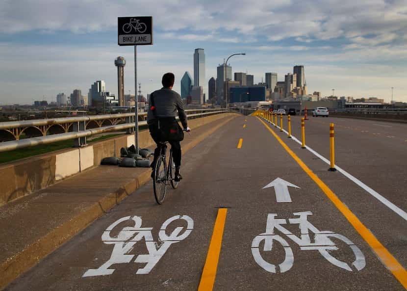 A morning commuter takes the bike lane across the Jefferson Boulevard viaduct into downtown...