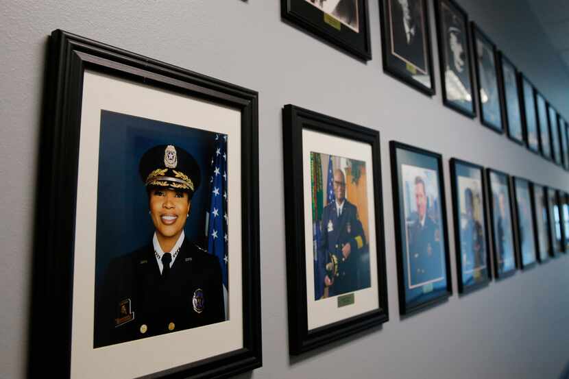 Dallas Police Chief U. Renee Hall's portrait next to past Dallas Police Chief's in a hallway...