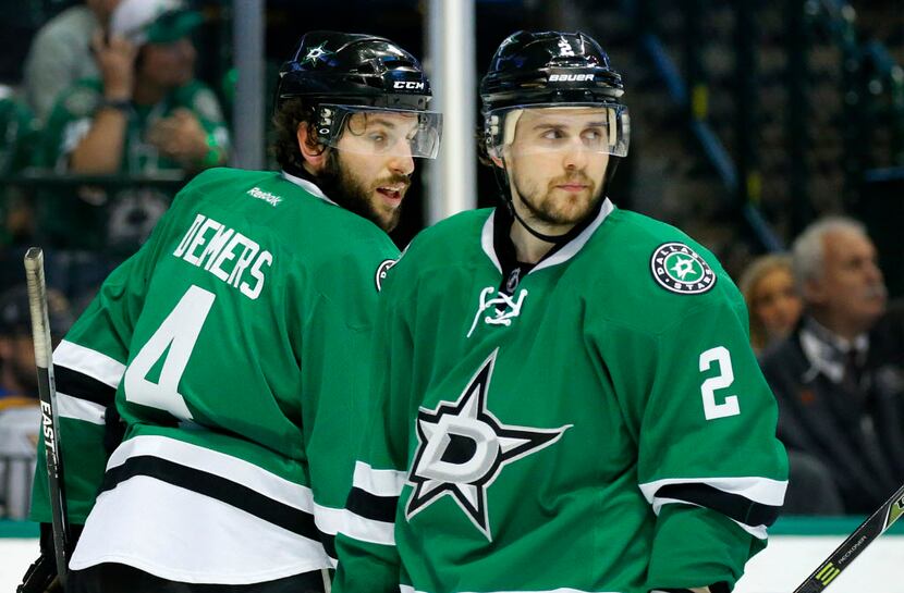 Dallas Stars defenseman Kris Russell (2) and Jason Demers (4) circle the ice after a whistle...