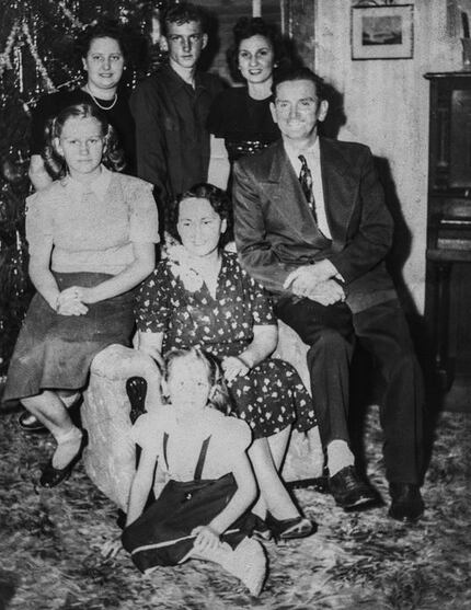 Albert "Buddy" Mills, at top center, with his parents and four sisters in a late 1940s...