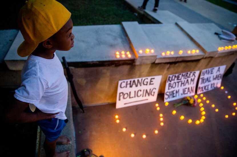 "Young King" Solomon Grayson, 6, stood  next to a memorial during a Mothers Against Police...