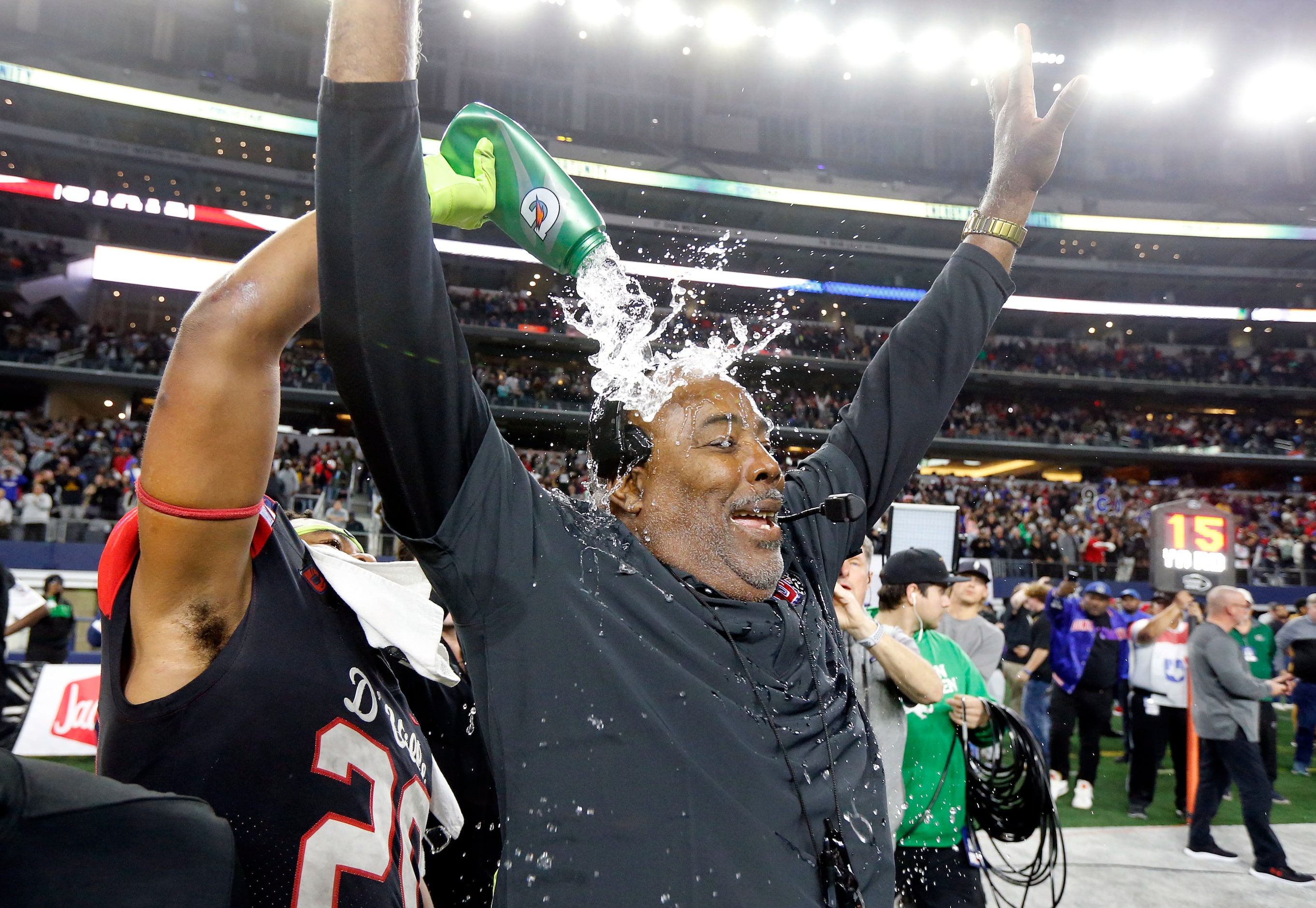 Duncanville head coach Reginald Samples is doused with water as he celebrates their Class 6A...