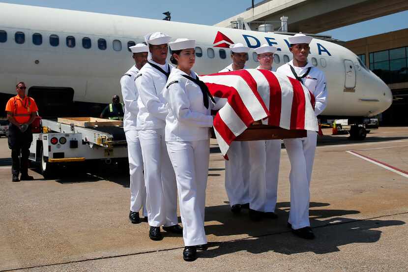 A Navy honor guard carries remains of Seaman 1st Class George A. Coke Jr. of Arlington as...