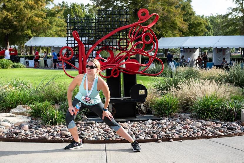 A participant at the Frisco Arts Walk & Run 2018 pauses for a stretch at the Texas Sculpture...