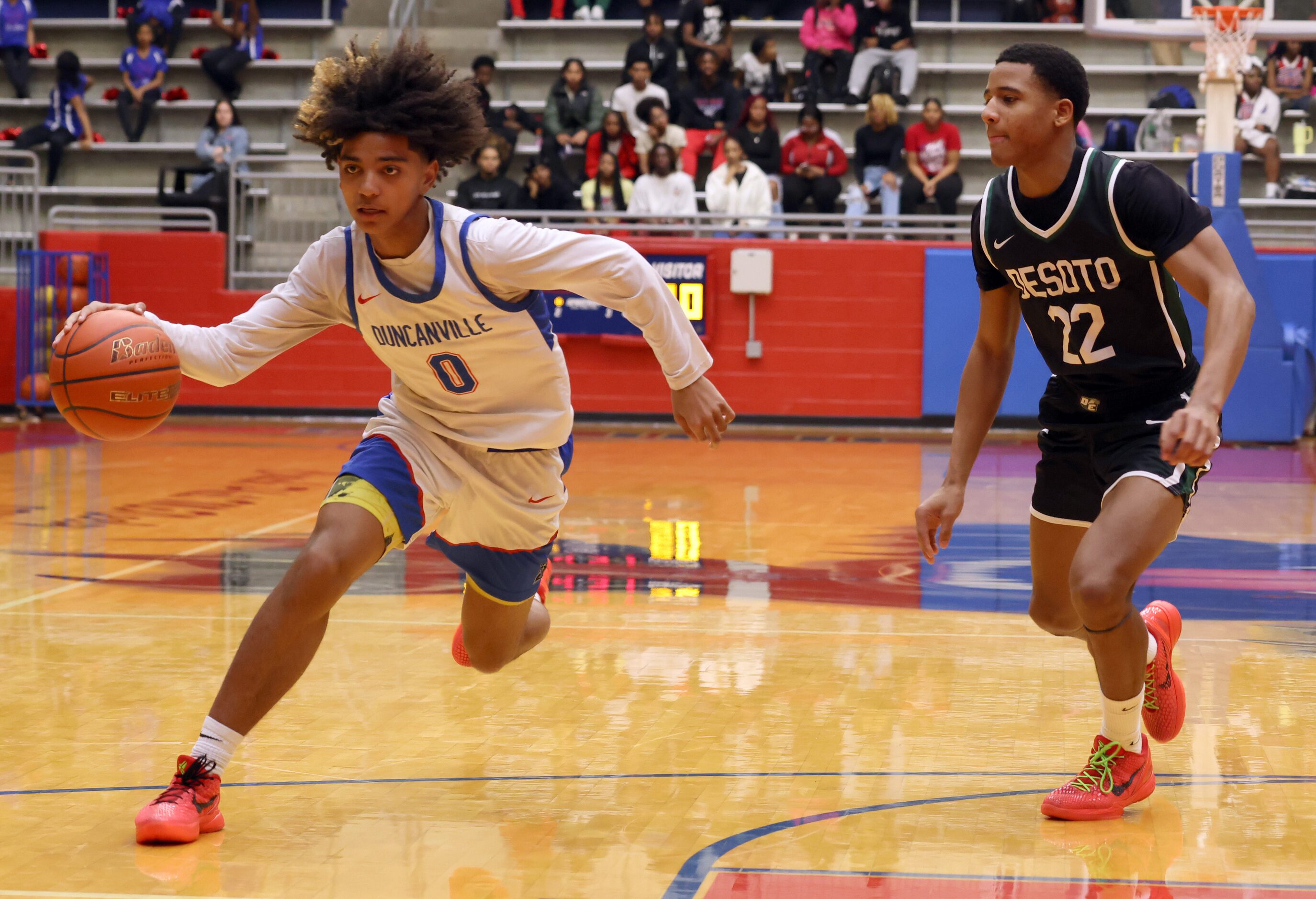 Duncanville guard Beckham Black (0) drives around the defense of DeSoto's William Langrum...