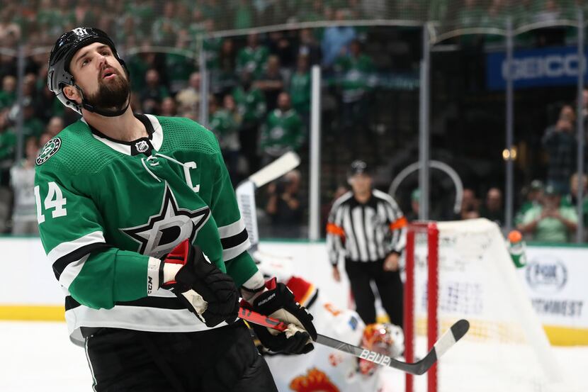 DALLAS, TEXAS - OCTOBER 10:  Jamie Benn #14 of the Dallas Stars reacts after a save by David...