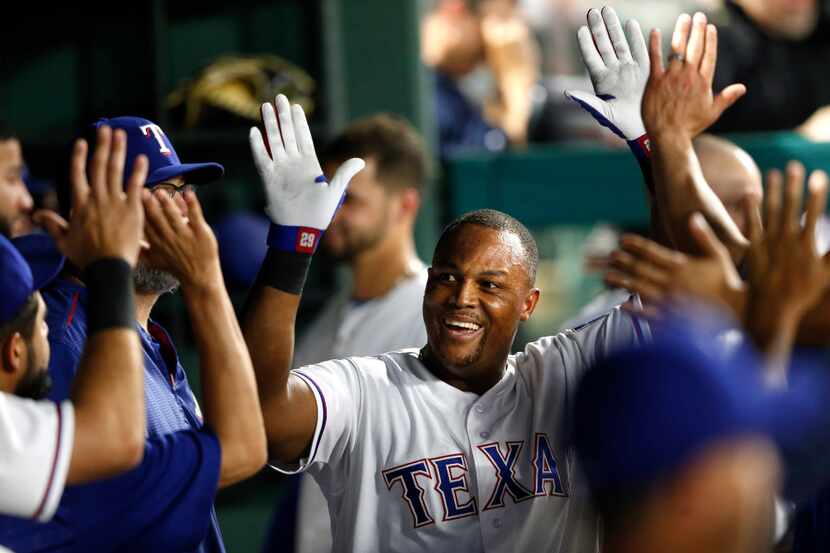 Texas Rangers third baseman Adrian Beltre (29) celebrates with teammates after hitting a...