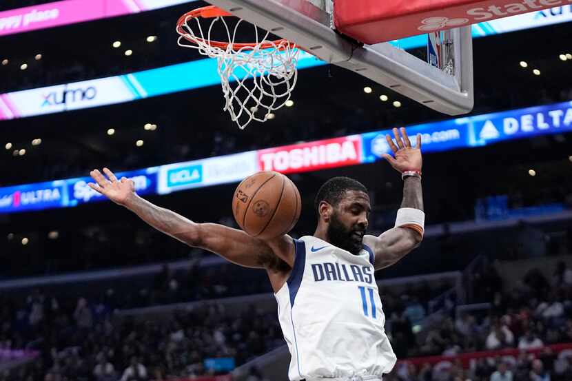 Dallas Mavericks guard Kyrie Irving dunks during the second half in Game 2 of an NBA...