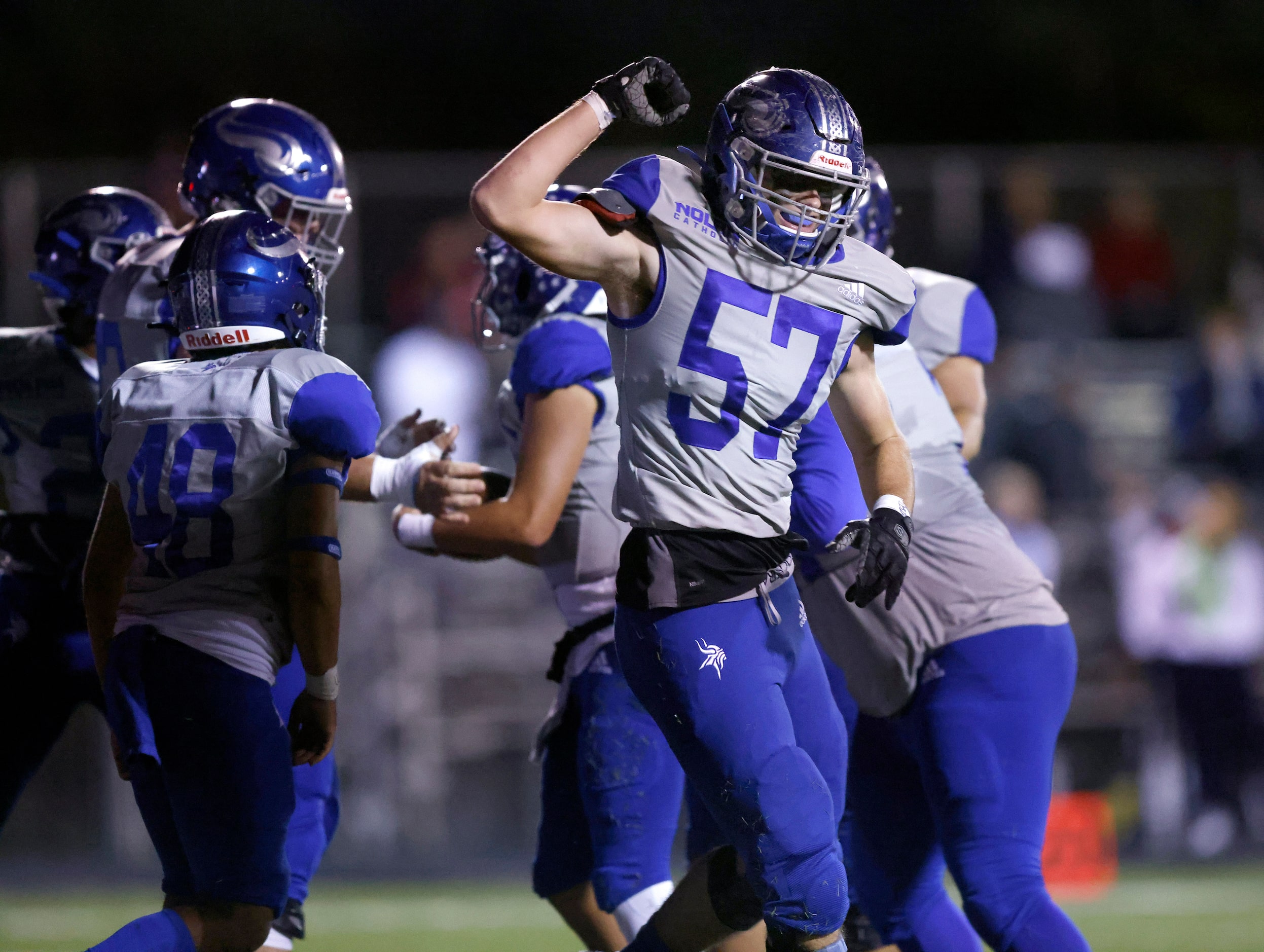 Fort Worth Nolan lineman Joseph Muraski (57) celebrates quarterback Cole Matsuda's first...