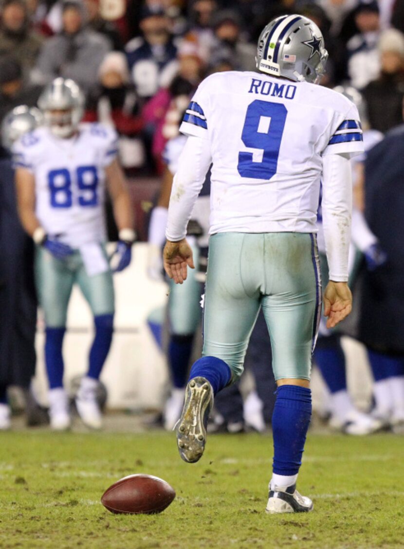 Dallas Cowboys quarterback Tony Romo (9) walks off the field after being sacked in the...