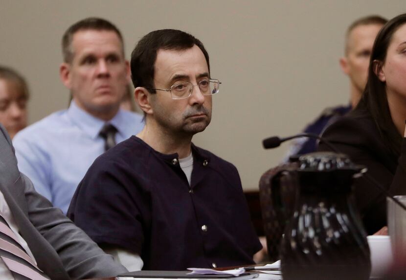 Larry Nassar sits during his sentencing hearing Jan. 24 in Lansing, Mich.  The former sports...