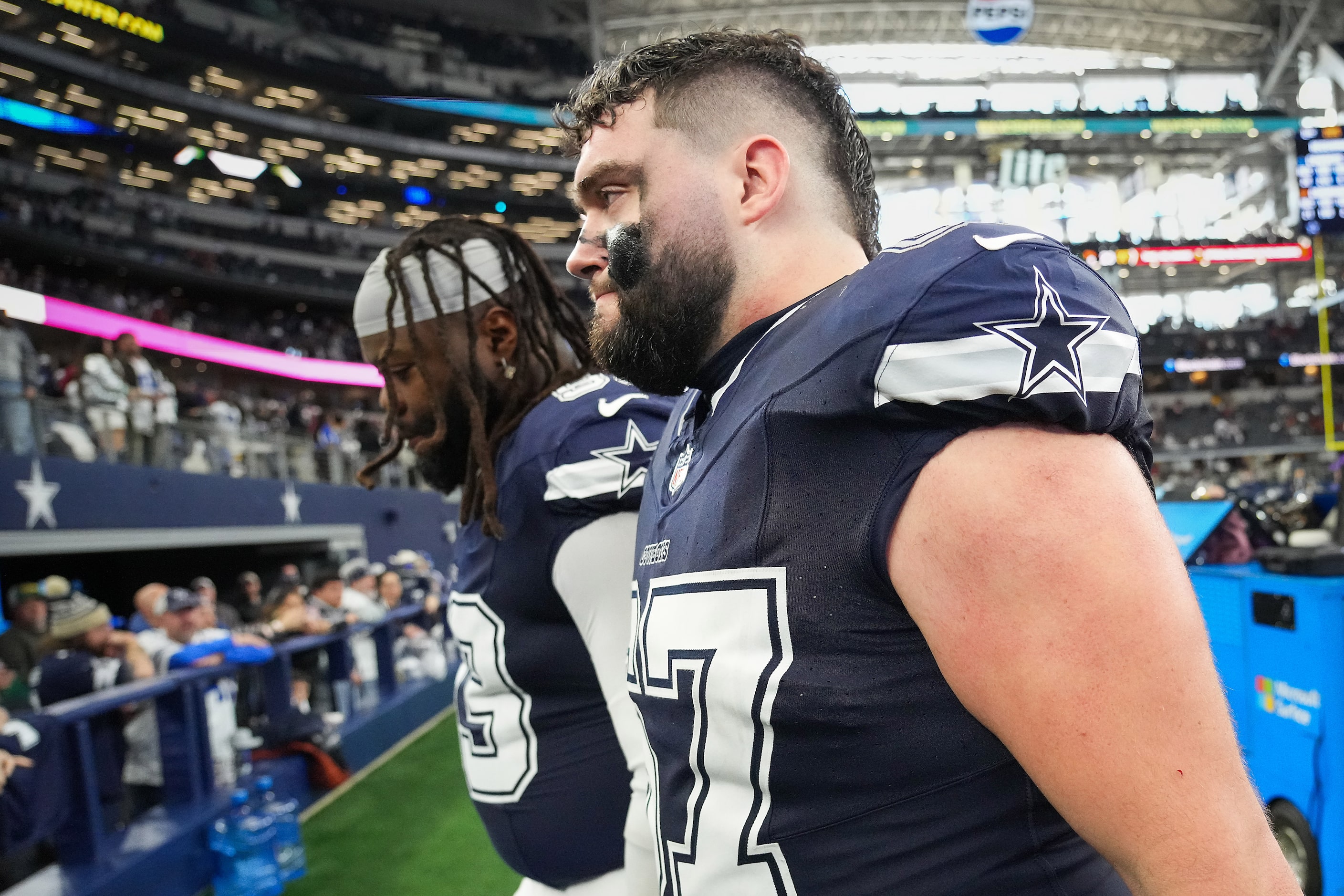 Dallas Cowboys center Brock Hoffman (67) and defensive tackle Linval Joseph (93) leave the...